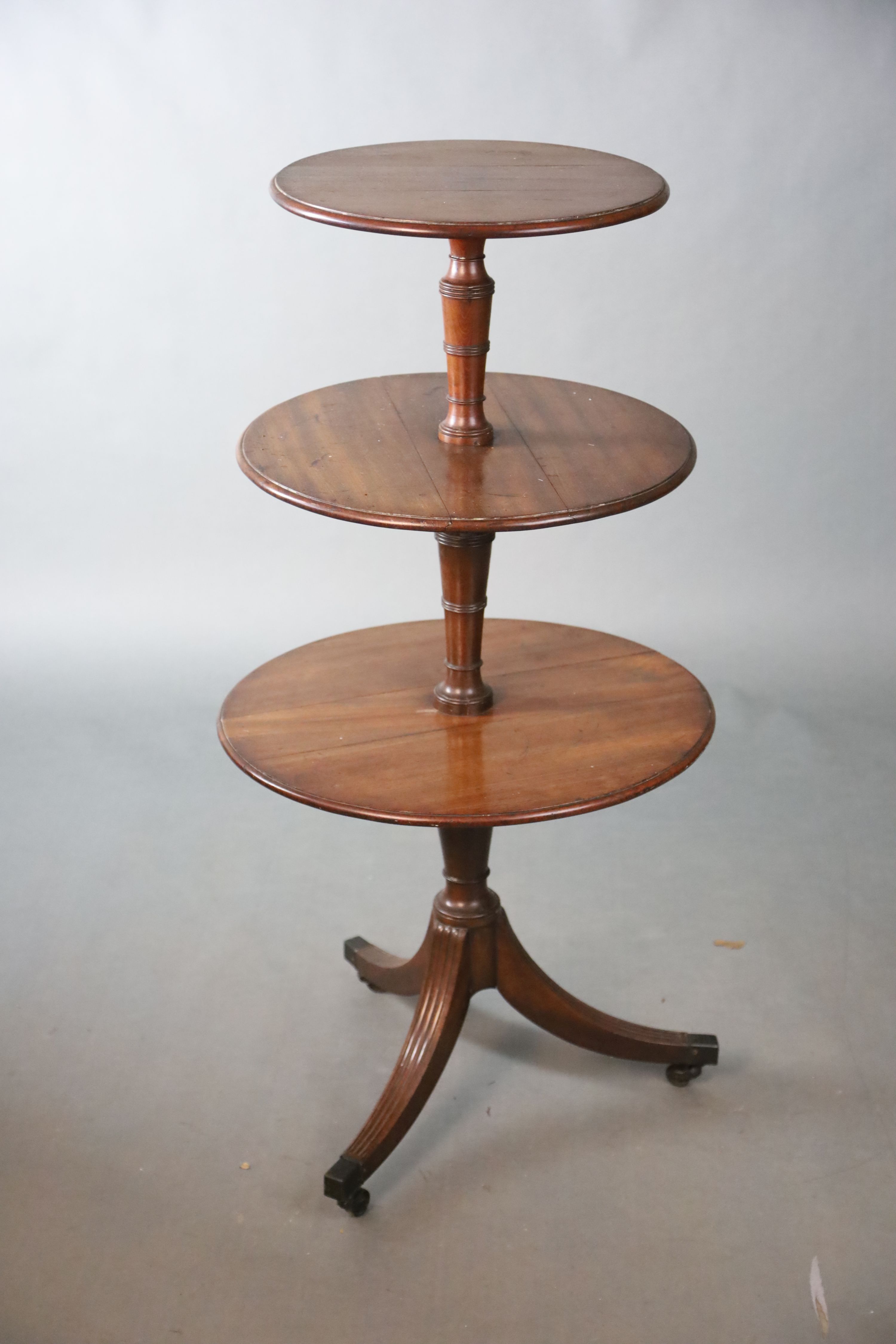 A Regency mahogany three tier dumb waiter, Diam. 58.5cm H.117cm